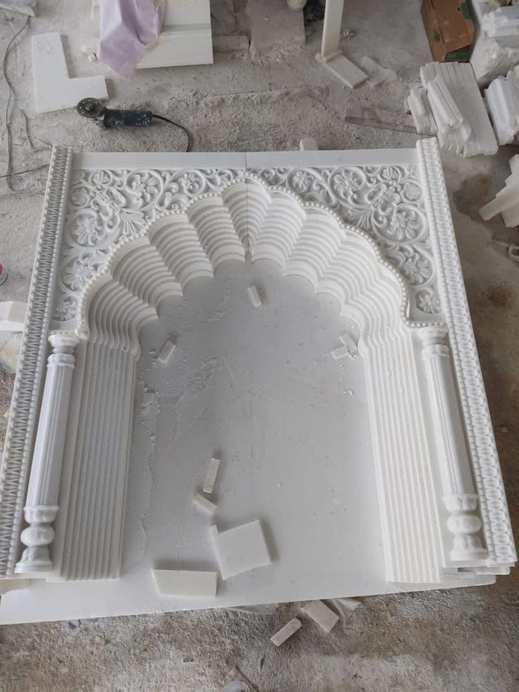 Carved marble arch panel being finished in the workshop