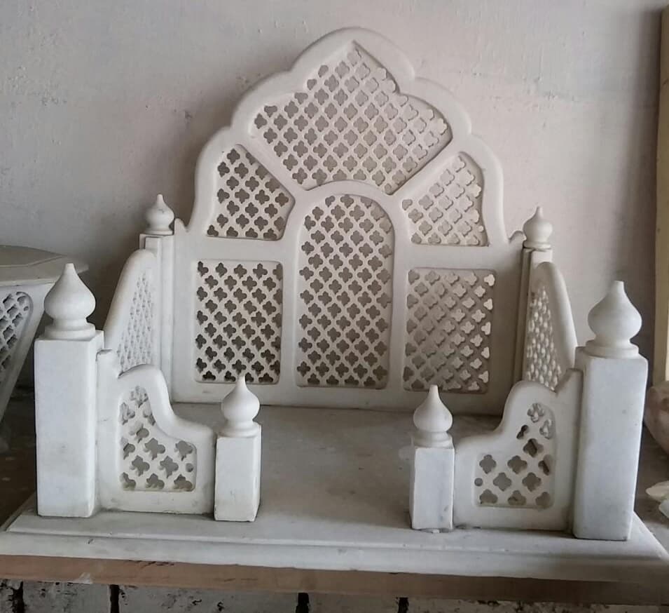 Low marble jali mandir with arched back panel