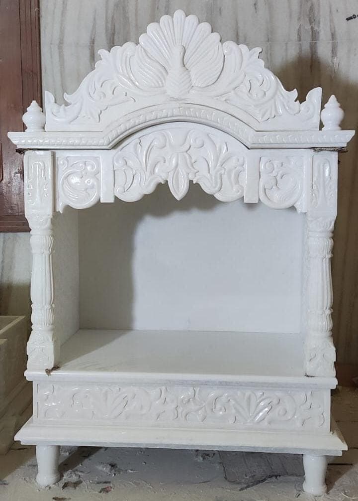 Design inspiration: white marble mandir with carved peacock crown and pillars