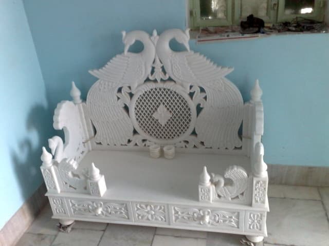 Low marble mandir with twin peacock back panel