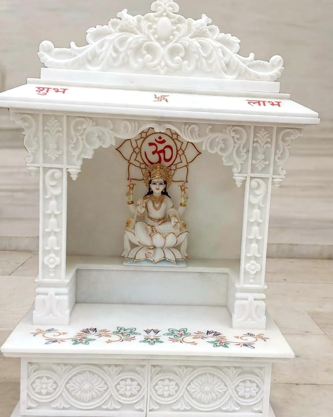 Carved marble mandir with Shubh Labh lettering, Om backdrop and floral inlay